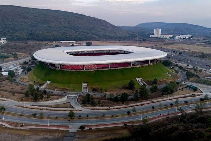A zoomed out picture of Guadalajara Stadium from the air, with a mountain in the background, at World Cup 2026.