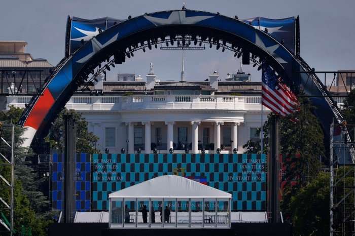 The UFC Octagon, with US flags on it, in front of the White House.
