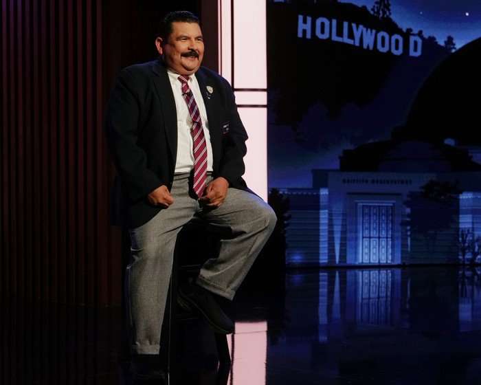 GUILLERMO RODRIGUEZ Guillermo Rodriguez wearing a suit and sat down smiling ahead.