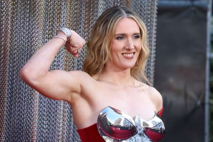 Abigail Thorn at the premiere of House of the Dragon season 3. Abigail Thorn at the premiere of House of the Dragon season 3. She's wearing a red dress and is tensing her biceps.