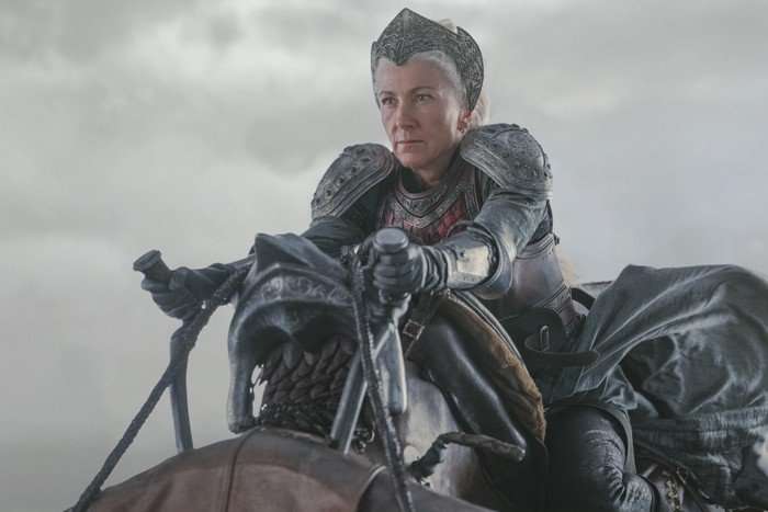 Eve Best as Rhaenys Targaryen in House of the Dragon Rhaenys Targaryen in House of the Dragon, wearing armour and sitting atop a dragon, who is out of shot below. There is a cloudy sky in the background.