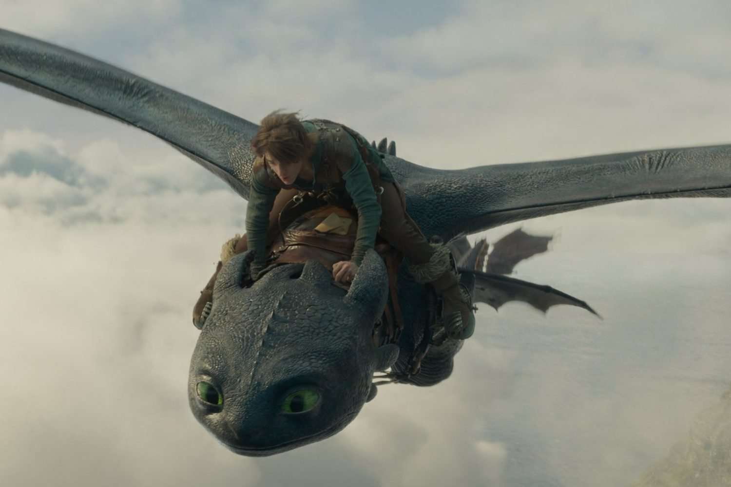 Hiccup rides a dragon in the skies in "How to Train Your Dragon" (2025).