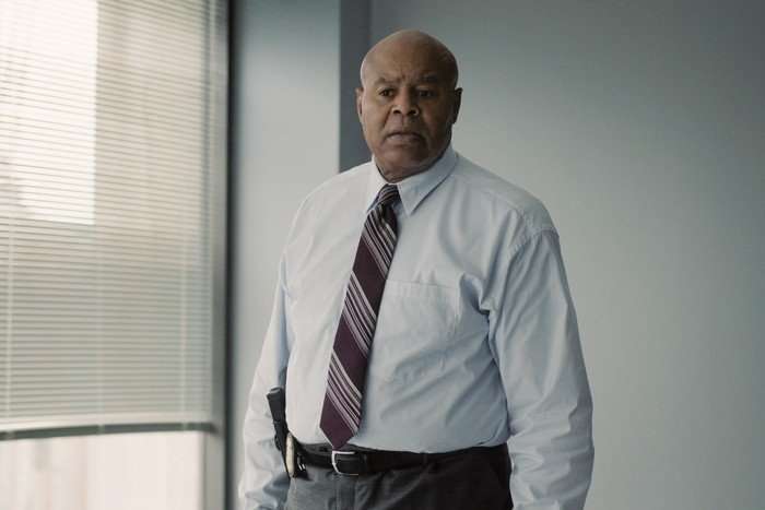 I Will Find You Chi McBride as Agent Max Williams in I Will Find You standing in his office, wearing a white shirt and tie.