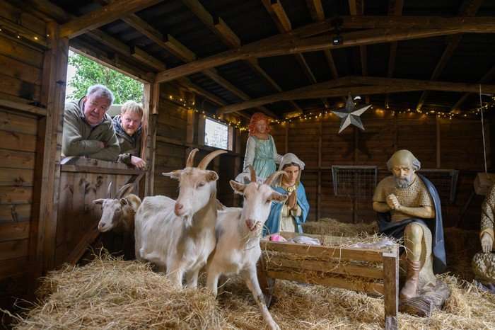 Jeremy Clarkson and Kaleb Cooper looking inside a shed with goats.
