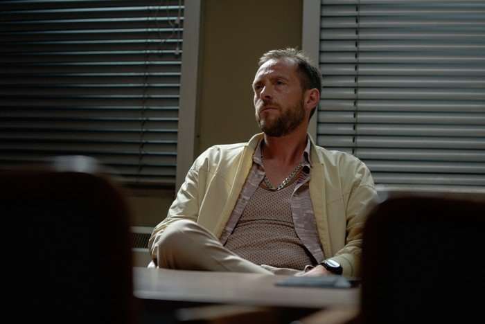 Little Disasters SE 1 EP 6 Stephen Campbell Moore as Rob Baird in Little Disasters sitting in a police interview room, looking blankly around.