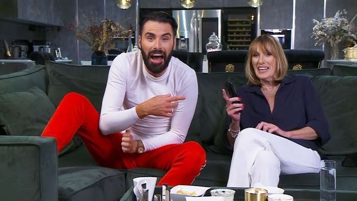 Rylan and Linda sat down next to each other on a green sofa.
