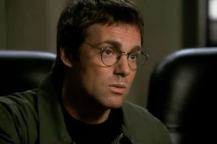 Michael Shanks as Daniel Jackson in Stargate SG1, wearing glasses and a green jacket.