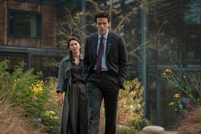 Ashley Zukerman as Daniel Keene and Jessica Henwick as Helen Drew in Silo season 3. The pair are pictured in a garden and Daniel is walking away from Helen.