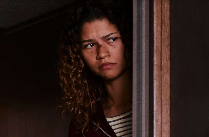 Euphoria Zendaya Zendaya looks from behind a wall as Rue Bennett in Euphoria season 3 episode 8.