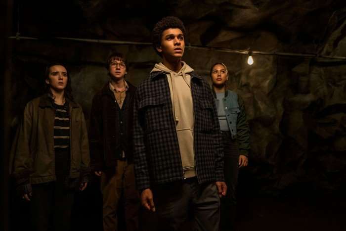 Adrian Greensmith (Arthur "Spoon" Spindell), Jaden Michael (Mickey Bolitar), Abby Corrigan (Ema Winslow), Sage Linder (Rachel Caldwell) Adrian Greensmith (Arthur "Spoon" Spindell), Jaden Michael (Mickey Bolitar), Abby Corrigan (Ema Winslow), Sage Linder (Rachel Caldwell) standing together in a dark room