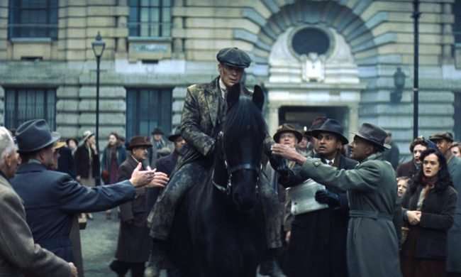 Tommy Shelby (Cillian Murphy) riding a horse through a crowd in Peaky Blinders The Immortal Man.