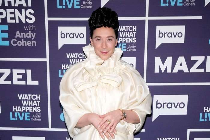 the-traitors-US Johnny Weir stood with hands clasped in front of him and smiling ahead.
