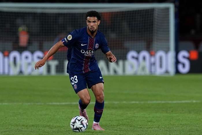 Warren Za&iuml;re-Emery, in blue and red PSG football kit, dribbles with the ball.