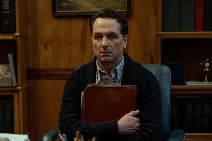 Matthew Rhys as Tom Loftis in Widow's Bay Matthew Rhys as Tom Loftis in Widow's Bay, clutching a folder and looking defeated while sitting at a desk