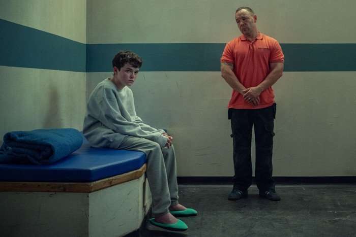 adolescence Owen Cooper and Stephen Graham as Jamie and Eddie Miller in Adolescence. They are in a prison cell, looking ahead.
