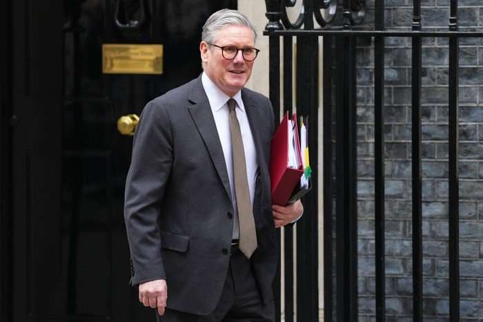 Keir Starmer Takes Prime Minister's Questions Sir Keir Starmer walking out of 10 Downing Street holding some folders.