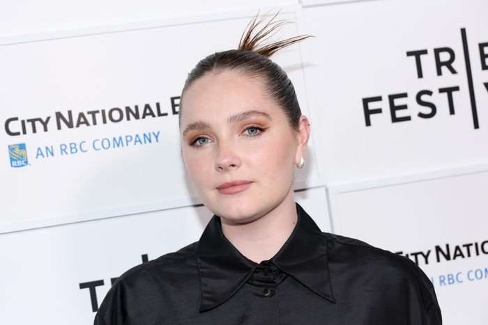 "The Gilded Age" Premiere - 2025 Tribeca Festival Amy Forsyth on the red carpet, wearing a black shirt with her hair in a bun.