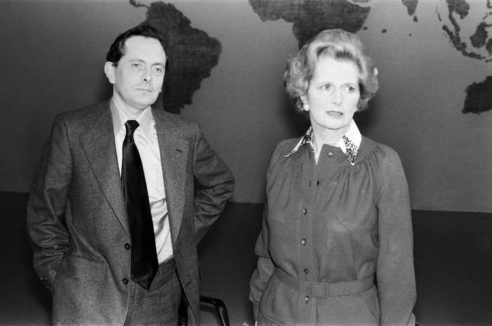 Black and white image of Margaret Thatcher and Brian Walden on the set of Weekend World in 1977, with a large map of the world in the background.
