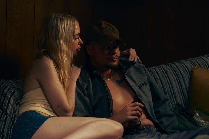 From left to right, Chloe Cherry as Faye Valentine sits caressing Toby Wallace as Wayne in the Euphoria season 3 finale.