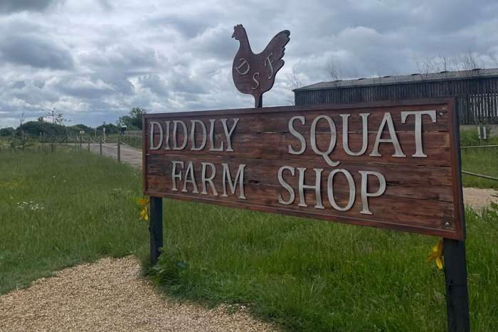 A sign that reads 'Diddly Squat Farm Shop'.