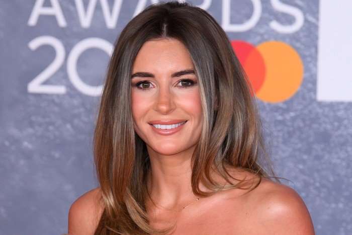 A close up of Dani Dyer, smiling ahead for the BRIT Awards red carpet.