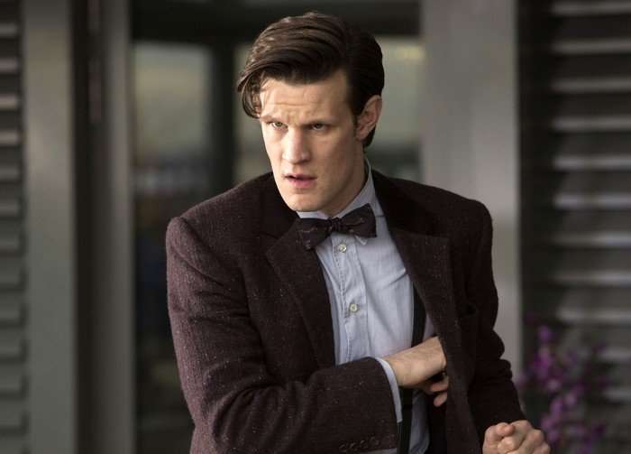 Matt Smith in Doctor Who The Eleventh Doctor looking perplexed and reaching into the inside pocket of his jacket.