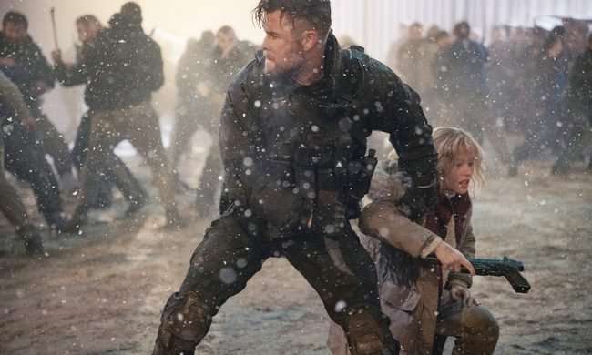 Tyler grips a child in battle in Extraction 2.