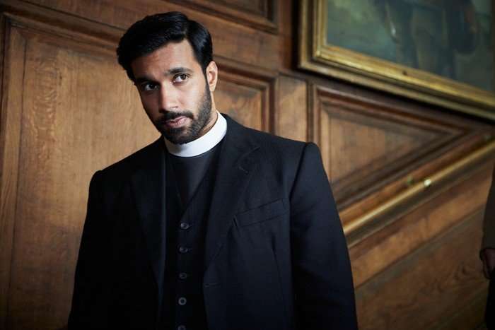 grantchester_10_episode_2_01 Rishi Nair as Alphy, dressed as a vicar as he descends the stairs and looks to the right