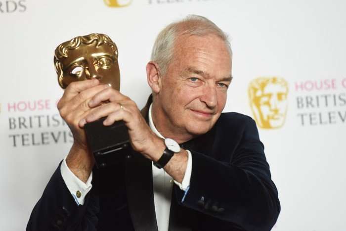 Jon Snow Jon Snow holding a BAFTA trophy in celebration.
