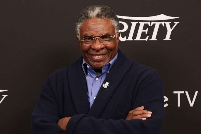 Keith David photographed at San Diego Comic-Con 2025, smiling directly at the camera with his arms crossed, stood before a backdrop bearing the Variety logo