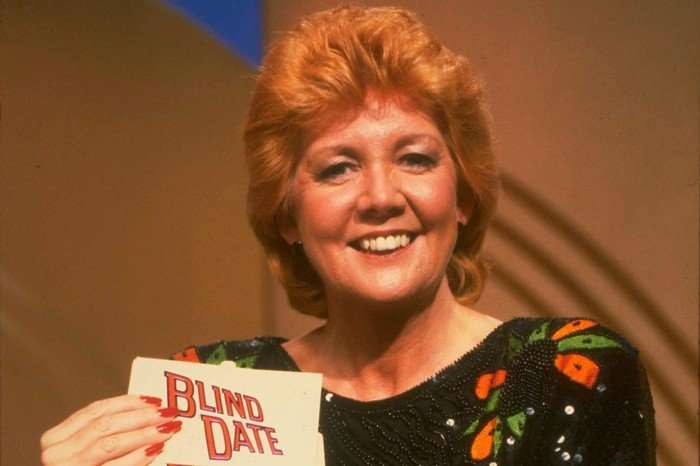 blind-date Cilla Black smiling ahead, holding cards that read Blind Date.