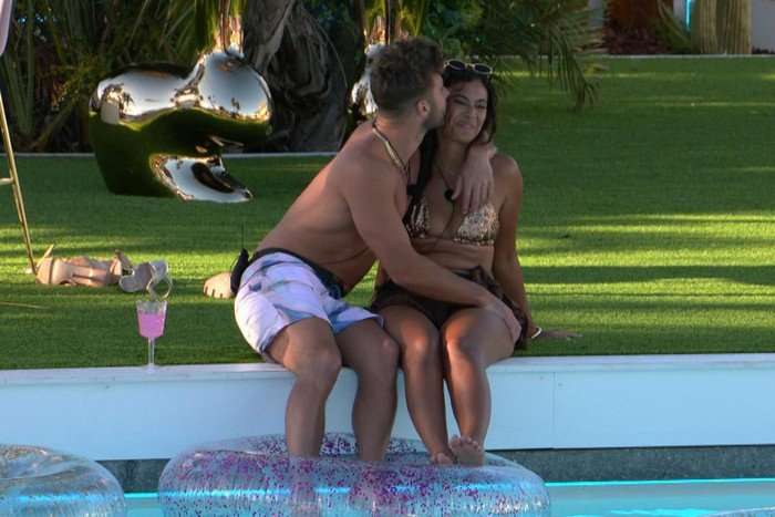 love-island-final-2 Josh and Sophie in an embrace dipping their toes into the swimming pool