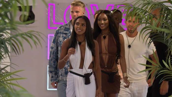 Namibia, Victoria and the Love Island boys walking into the villa.