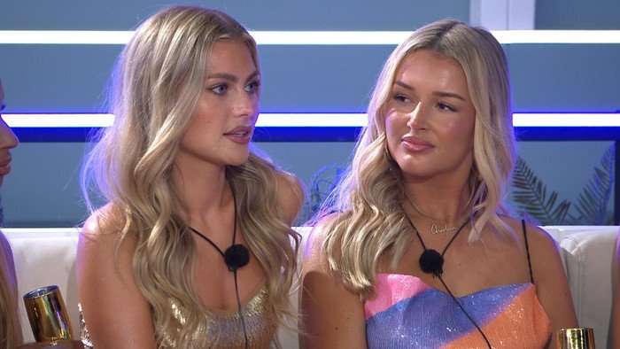 Charleen sat next to and looking at Martha with a smile.