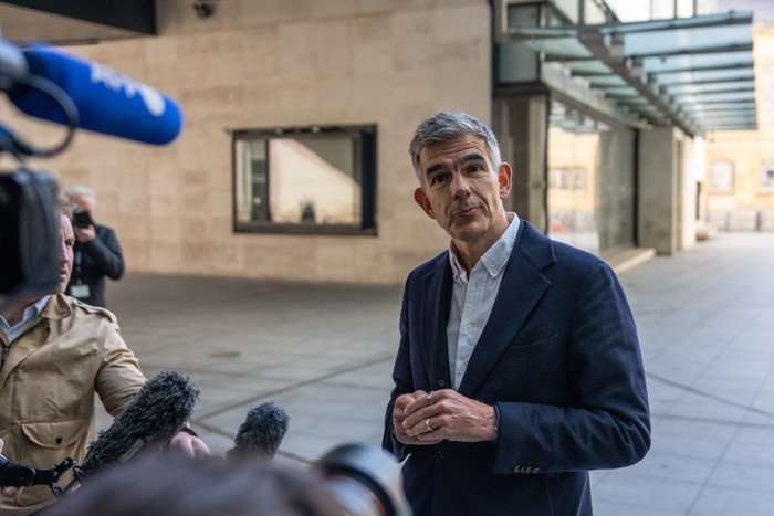 BBC director-general, Matt Brittin BBC director-general, Matt Brittin talking in front of news cameras, microphones and journalists.