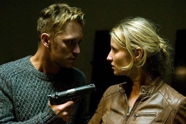 No Second Chance In a dimly lit indoor setting, a man in a grey knit sweater holds a handgun while facing a blonde woman in a brown leather jacket. The two stand close together, making intense eye contact, creating a tense and suspenseful atmosphere. The dark background keeps the focus on their expressions and the weapon.