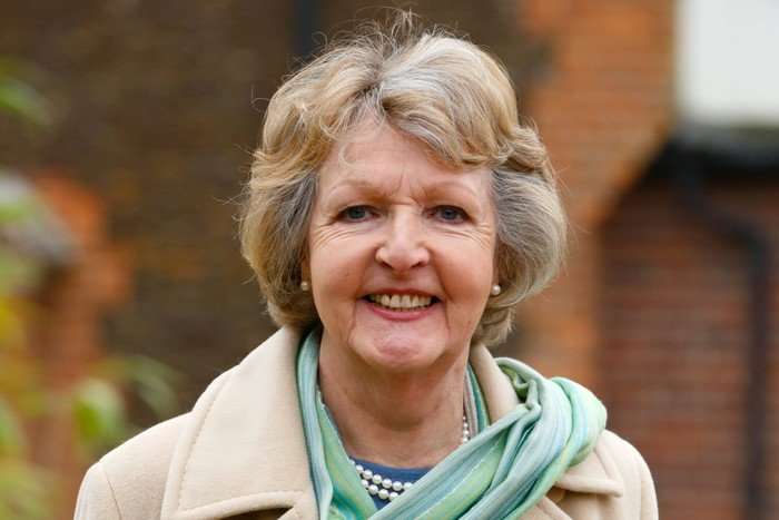 Penelope Keith smiling and wearing a green scarf.