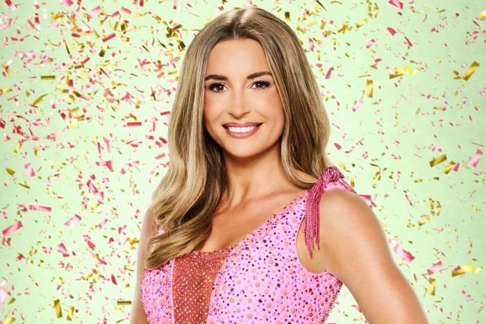 strictly-come-dancing (10) Dani Dyer wearing a sparkly pink dress smiling ahead.