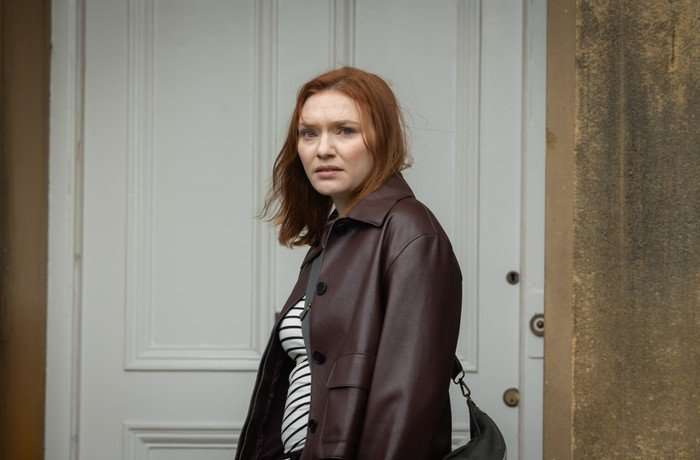 The Fortune Eleanor Tomlinson as Amanda Blakefield in The Fortune standing outside a house, looking scared as she approaches the front door and turns around.