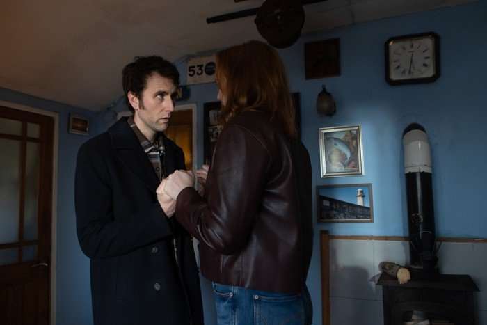 The Fortune Matthew Lewis as Jimmy Brent looking stressed and holding the hands of Eleanor Tomlinson as Amanda Blakefield in The Fortune.
