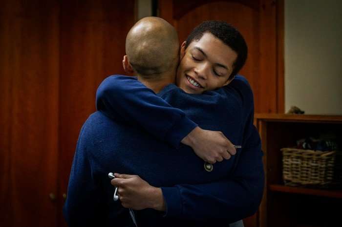 Jordan Bolger as Andr&eacute; Hanscombe and Max Fincham as Alex Hanscombe in The Witness hugging while smiling.