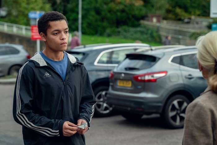 Max Fincham as Alex Hanscombe in The Witness approaching a woman in a car park, looking nervous.