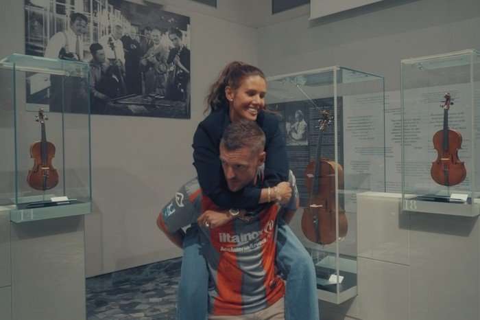 Rebekah Vardy on Jamie Vardy's back in a piggyback position.