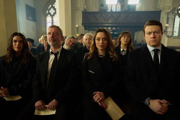 (L-R) Sabrina Bartlett as Bella, John Simm as Gray Wright, James Fleet as Bobby, Gemma Jones as Rose Wright, Zoe Tapper as Georgia Wright, Ruby Ashbourne Serkis as Emily and Daniel Rigby as John Wright in I, Jack Wright in a church