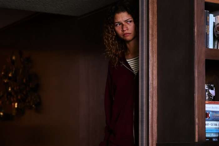 Zendaya lurks behind a doorway as Rue Bennett in the Euphoria season 3 finale.