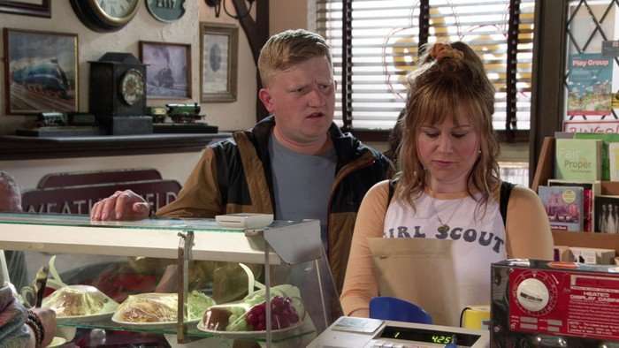 Chesney and Gemma look shocked looking at a piece of paper.