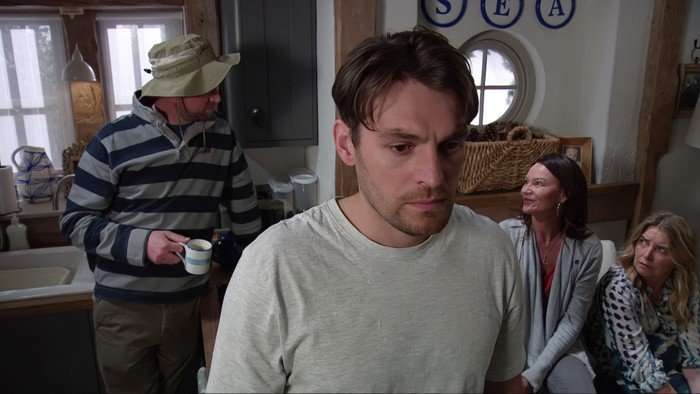 15_07_emm_mack_charity_01 Mack looks worried as Liam, Chas and Charity chat behind him in a scene from Emmerdale
