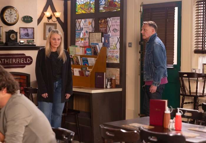 Lisa stands vacant beside Sean in the caff in Coronation Street