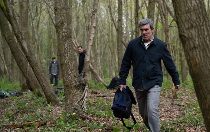 Cain storms away from Kyle and Graham in a scene from Emmerdale