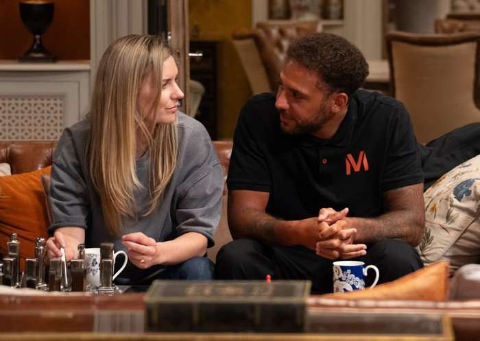 Dawn and Billy sat on the sofa beside each other in Emmerdale